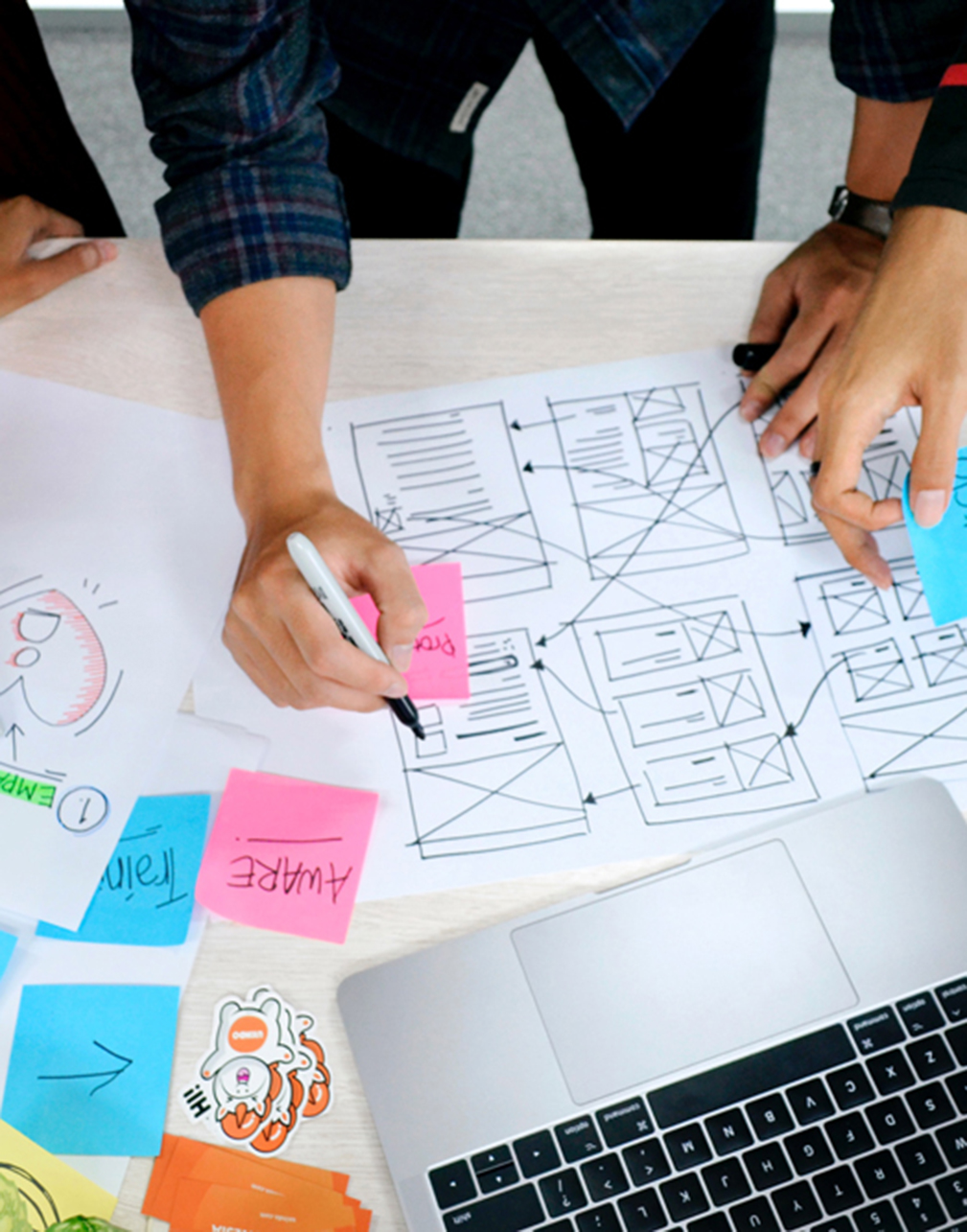 Multiple people working on a websites UX frames