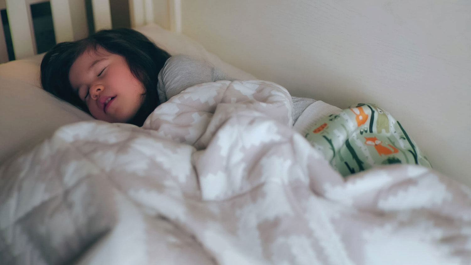 A happy girl sleeping in her bed