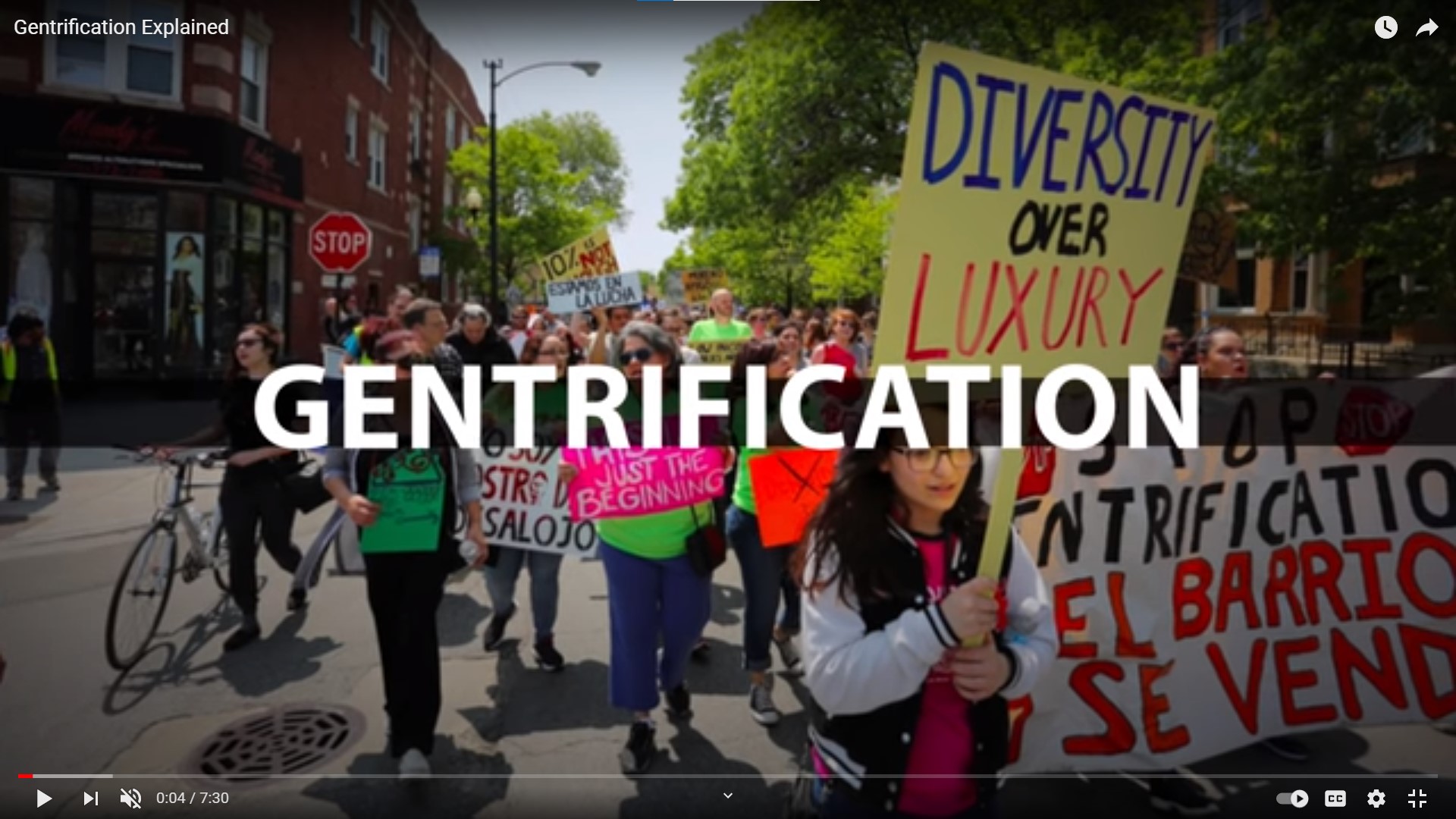 Image of people marching in protest against gentrification.