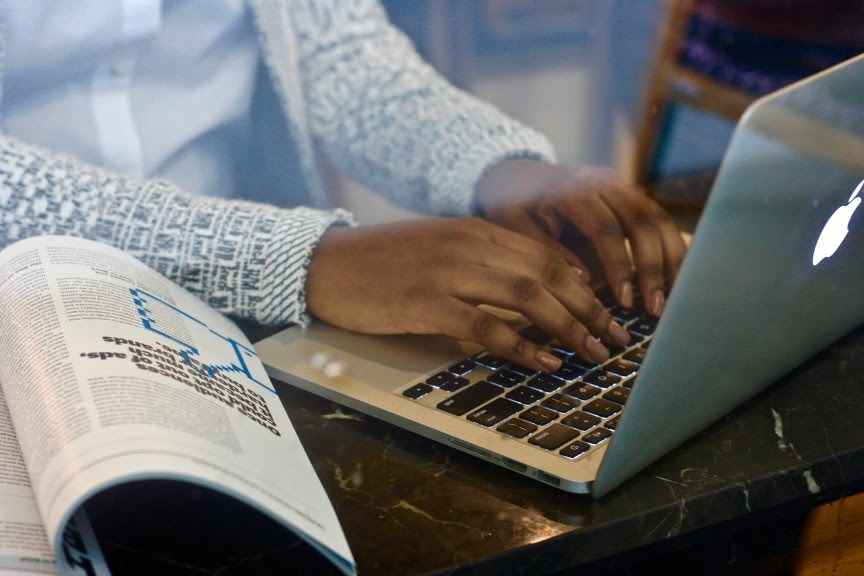 nonprofit board consultant writing in her nonprofit blog via her laptop.