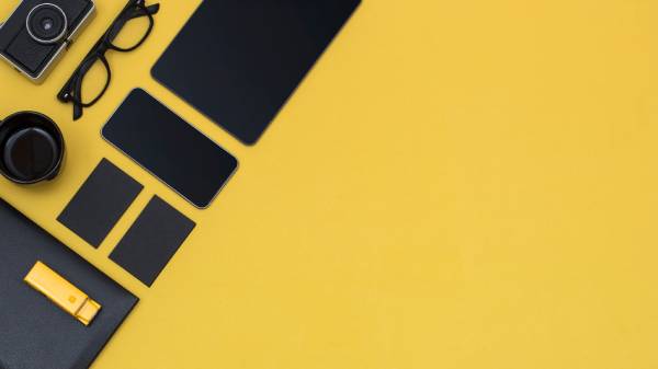 A range of tech devices set against a bright yellow background.