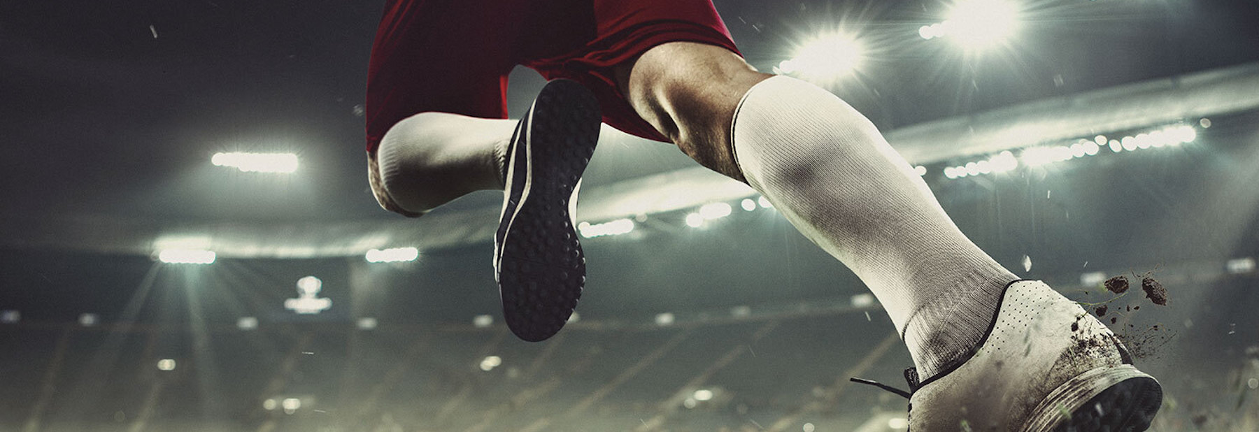 A close-up shot of a football player's leg as they sprint off the end line.