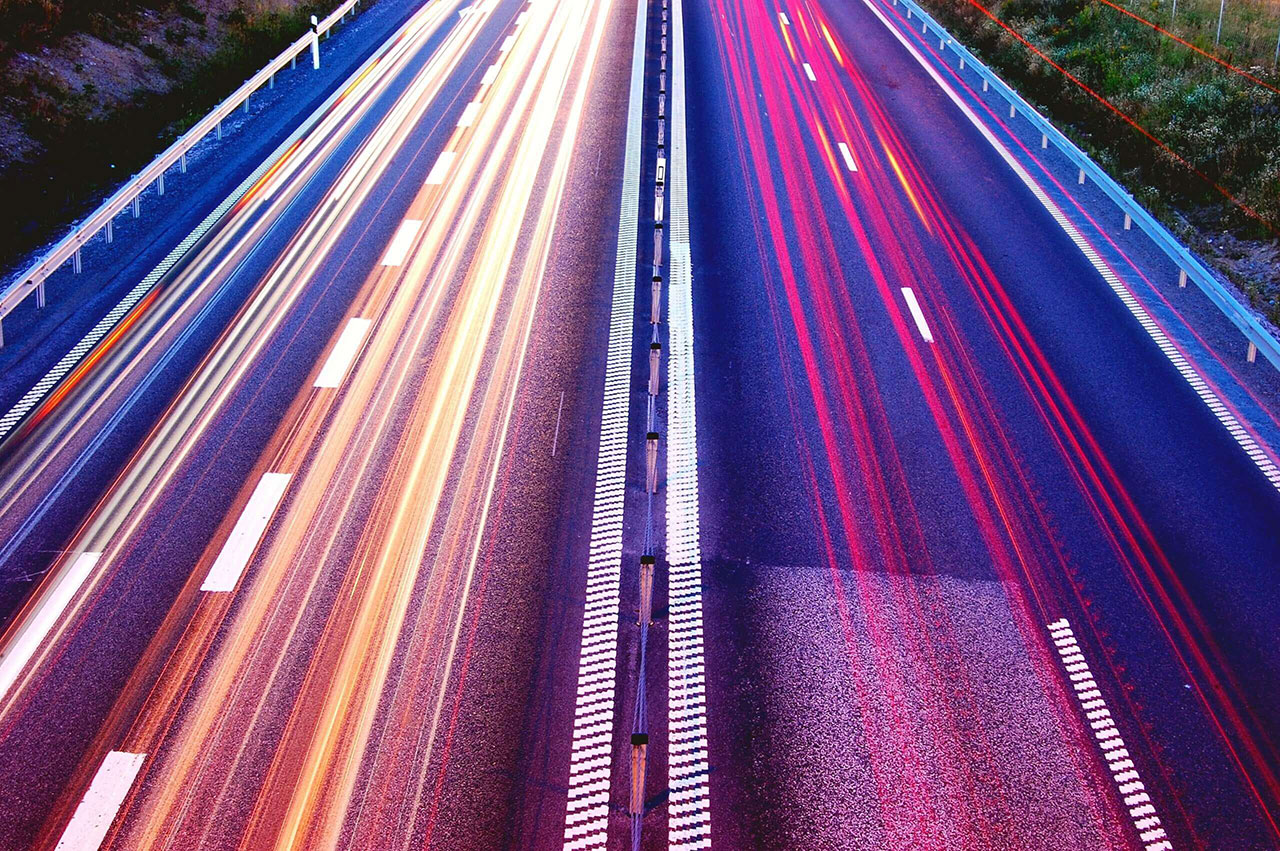 A overhead, long-exposure image of a busy motorway.