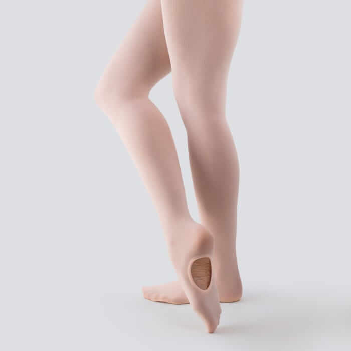 A girl demonstrating wearing junior, senior and advanced pink ballet tights