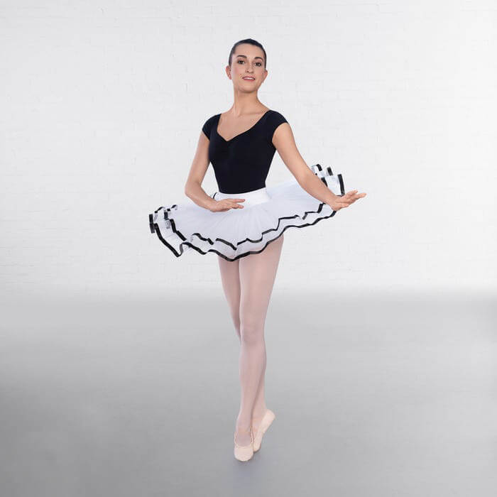 A woman demonstrates the senior and advanced white tutu skirt with black details