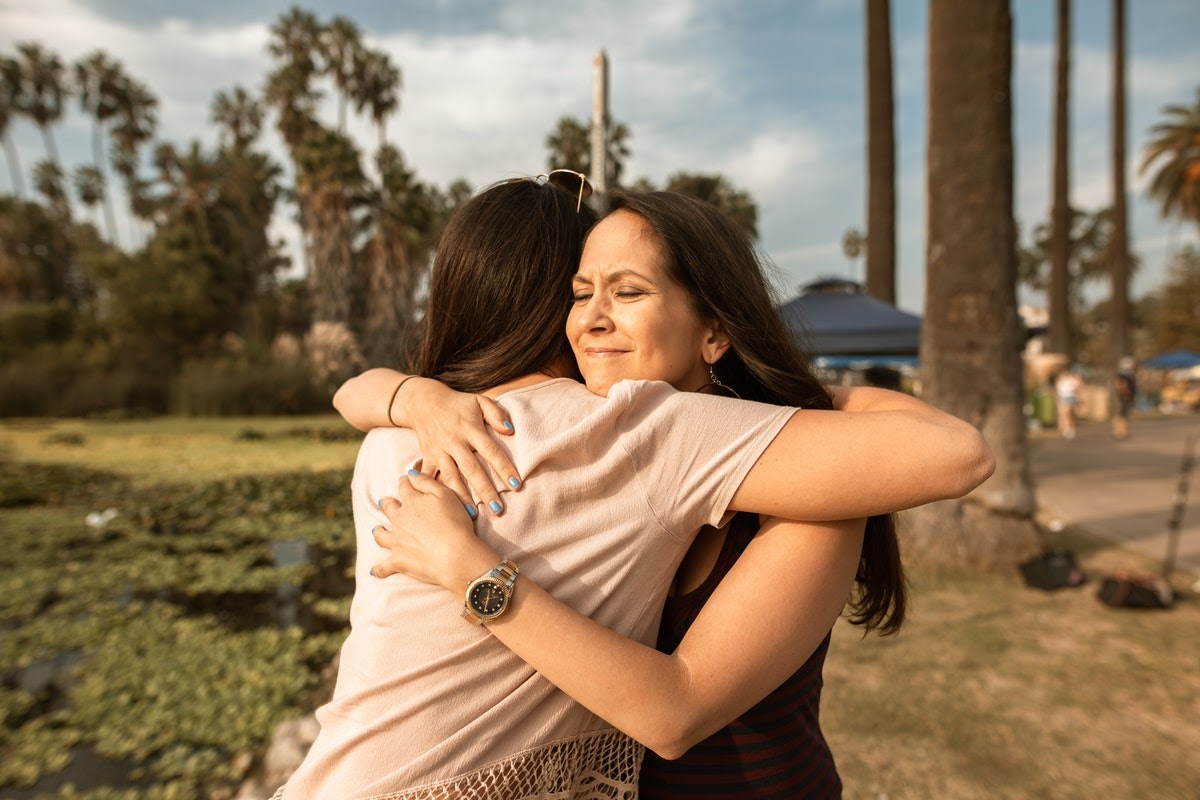 Woman hugging support system after TMS