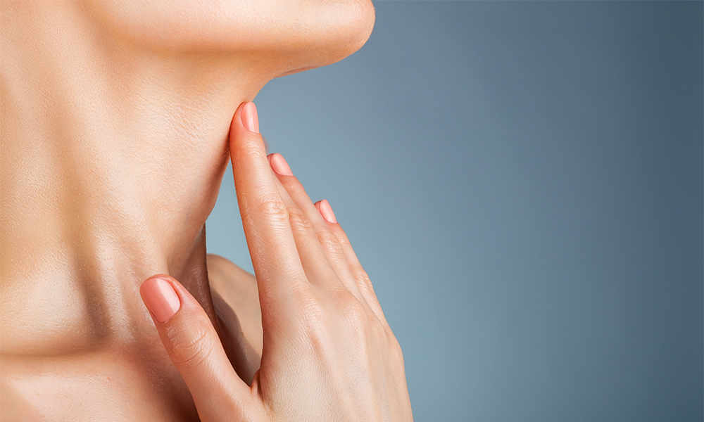 Woman with hand on her neck