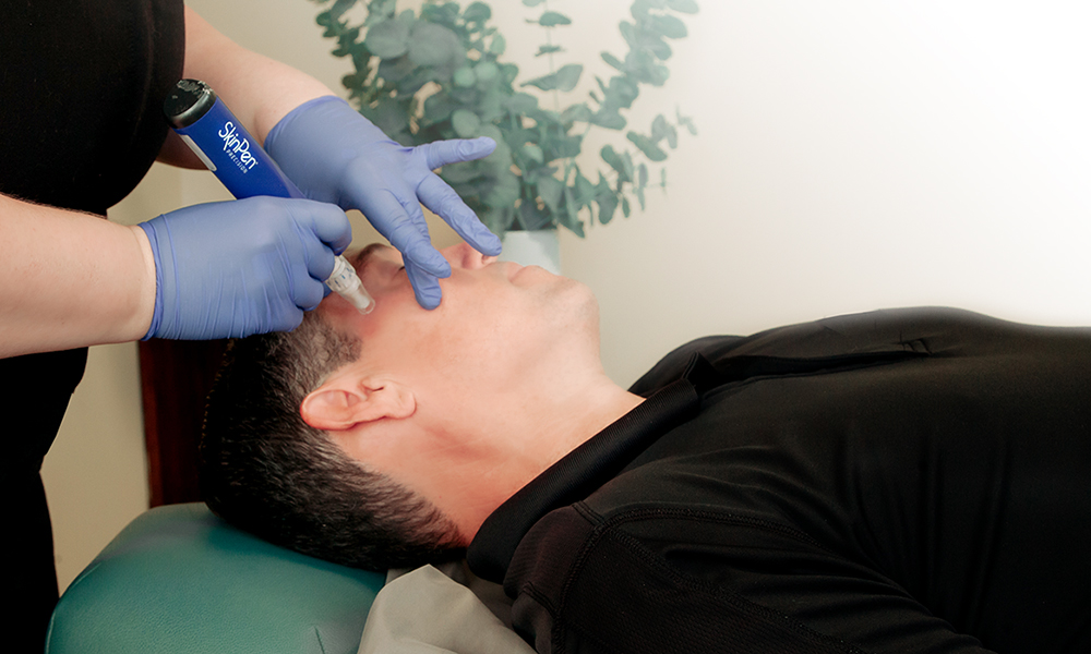 Male receiving Microneedling with the SkinPen at SkinReMEDI by Natural Body Spa