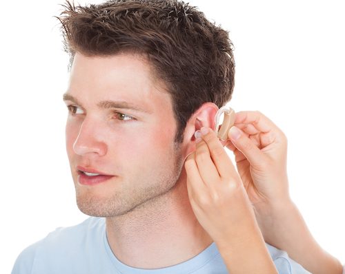 person getting fitted with a hearing aid