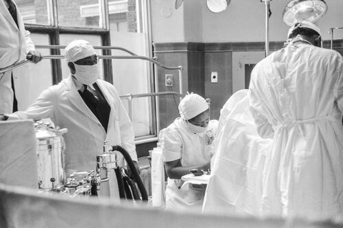 Black and white image of doctors wearing PPE gear.