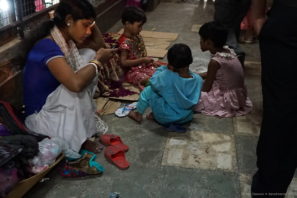 Indian children playing games and checking texts.