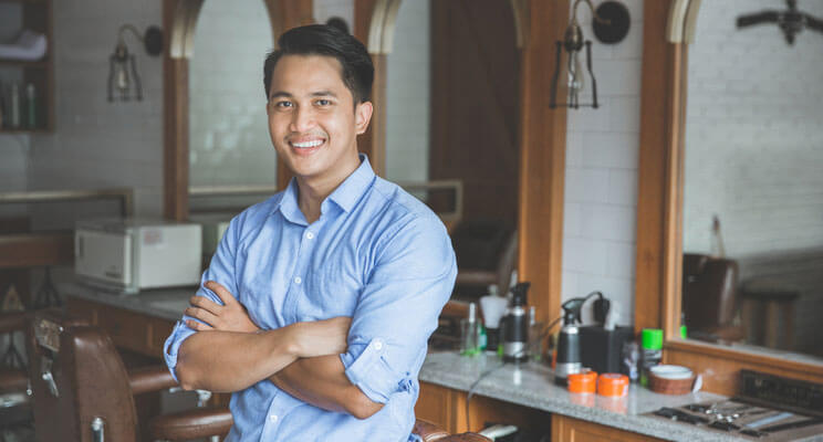 Smiling man standing in a salon