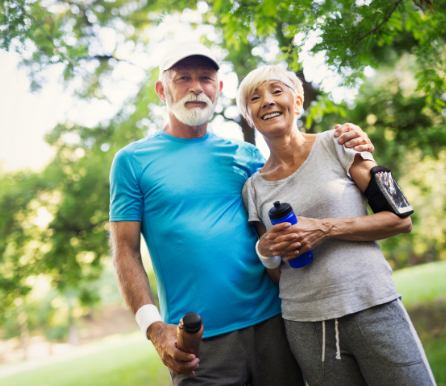 Photo of a smiling older couple on a brisk walk, empowered to take care of their bodies by using Eva Medtec's therapy pad.