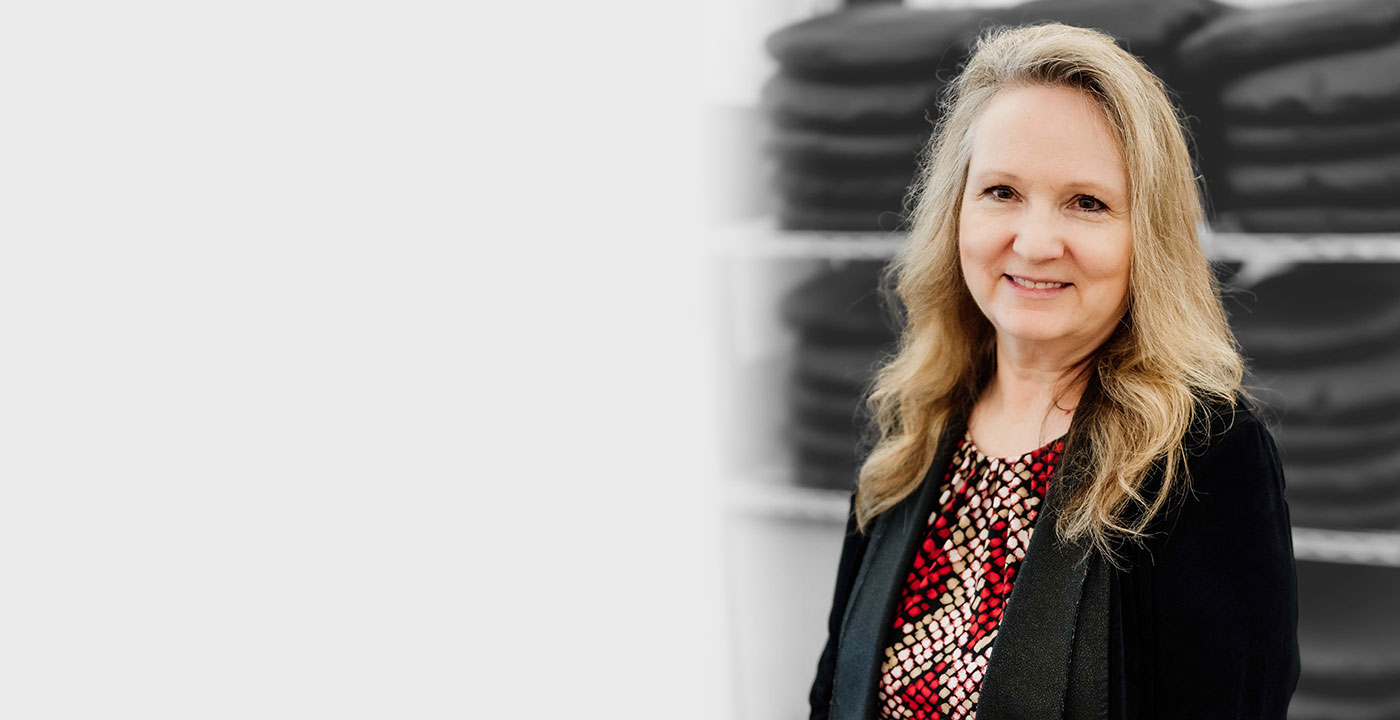 An image of Eva Medtec founder and Neuroglide inventor Irene Waldrige, wearing a blazer and smiling.