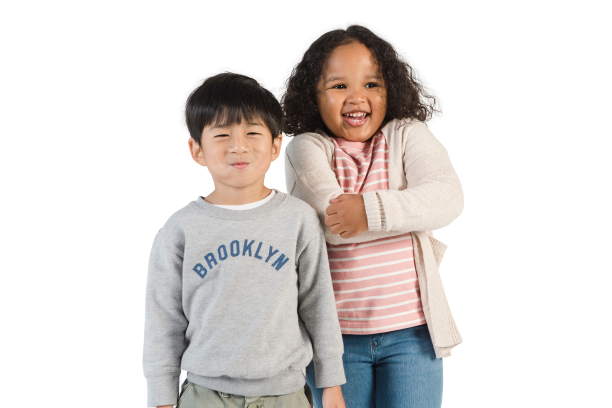 Two kids, one boy, and one girl smiling together