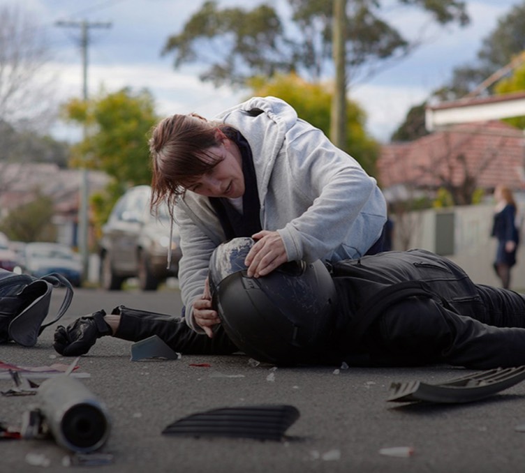 A still from our Aware Super campaign depicting a nurse assisting the victim of a motorcycle accident.