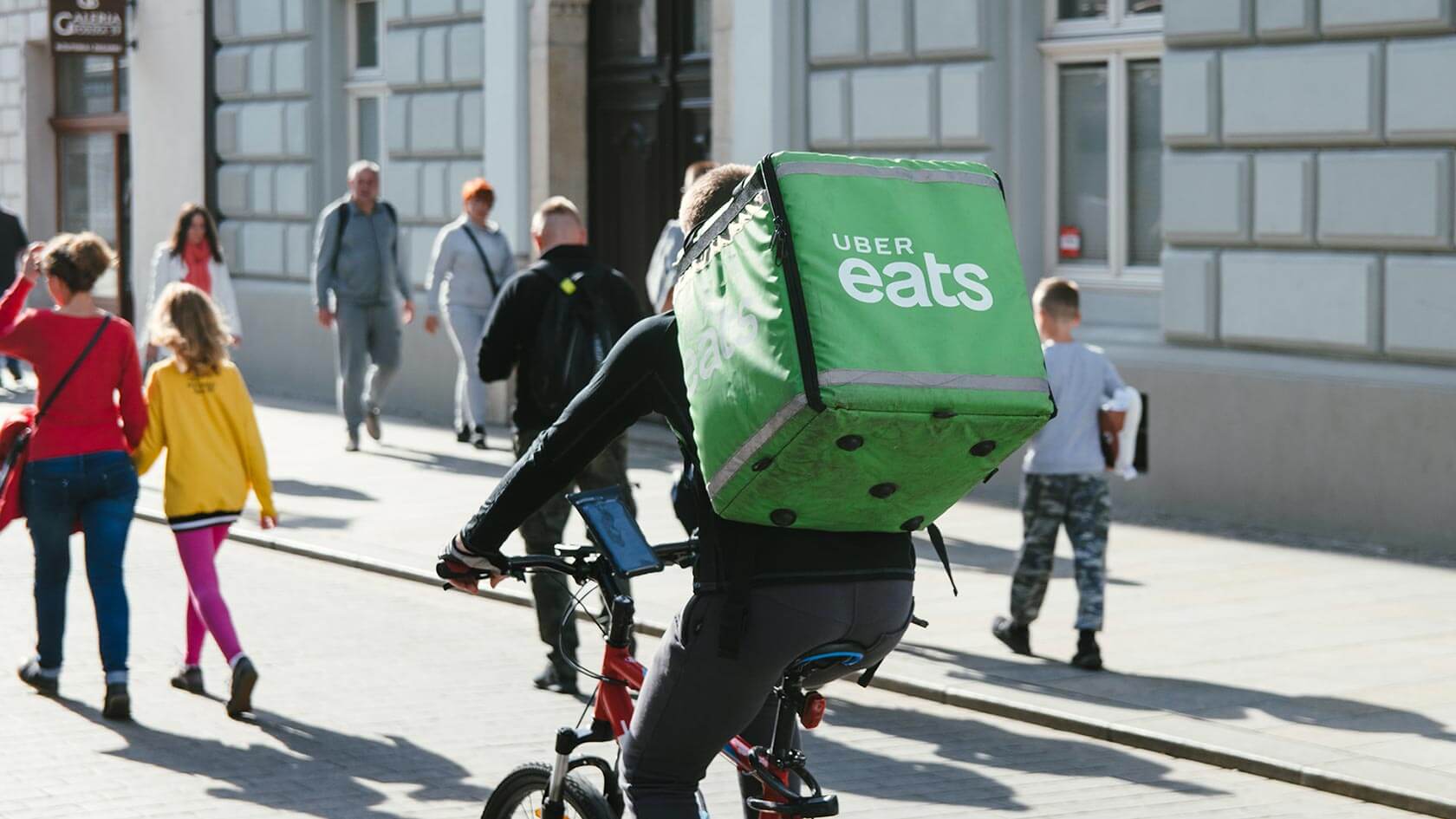 An Uber Eats delivery rider riding his bicycle