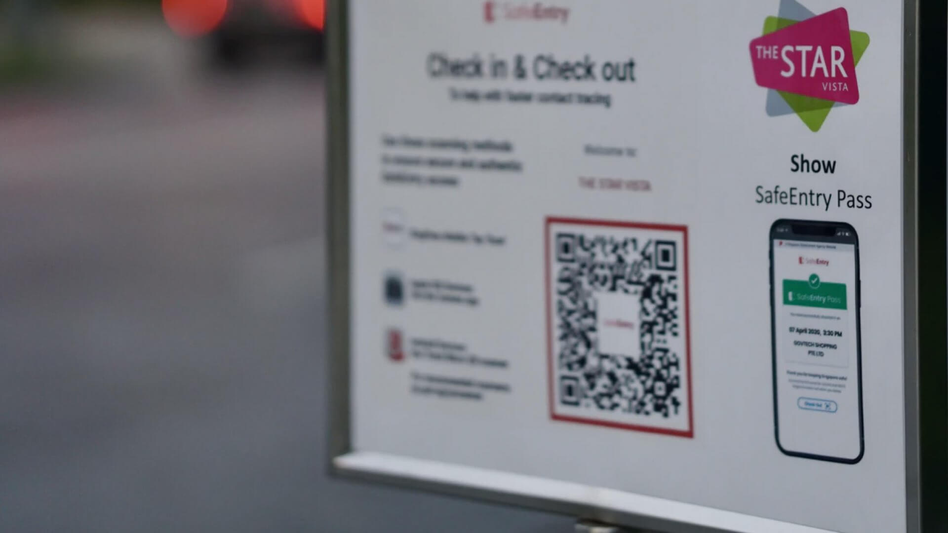 A venue Check-In sign with QR Code.