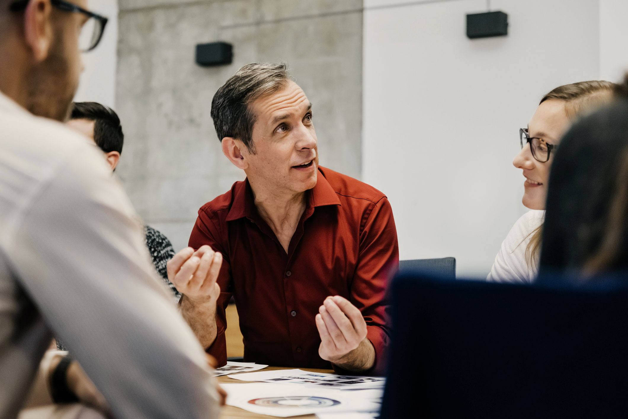 A group of people having a discussion in an office