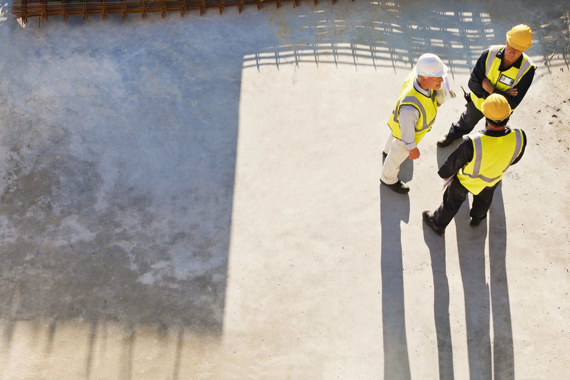 Three workers in high visibility safety wear