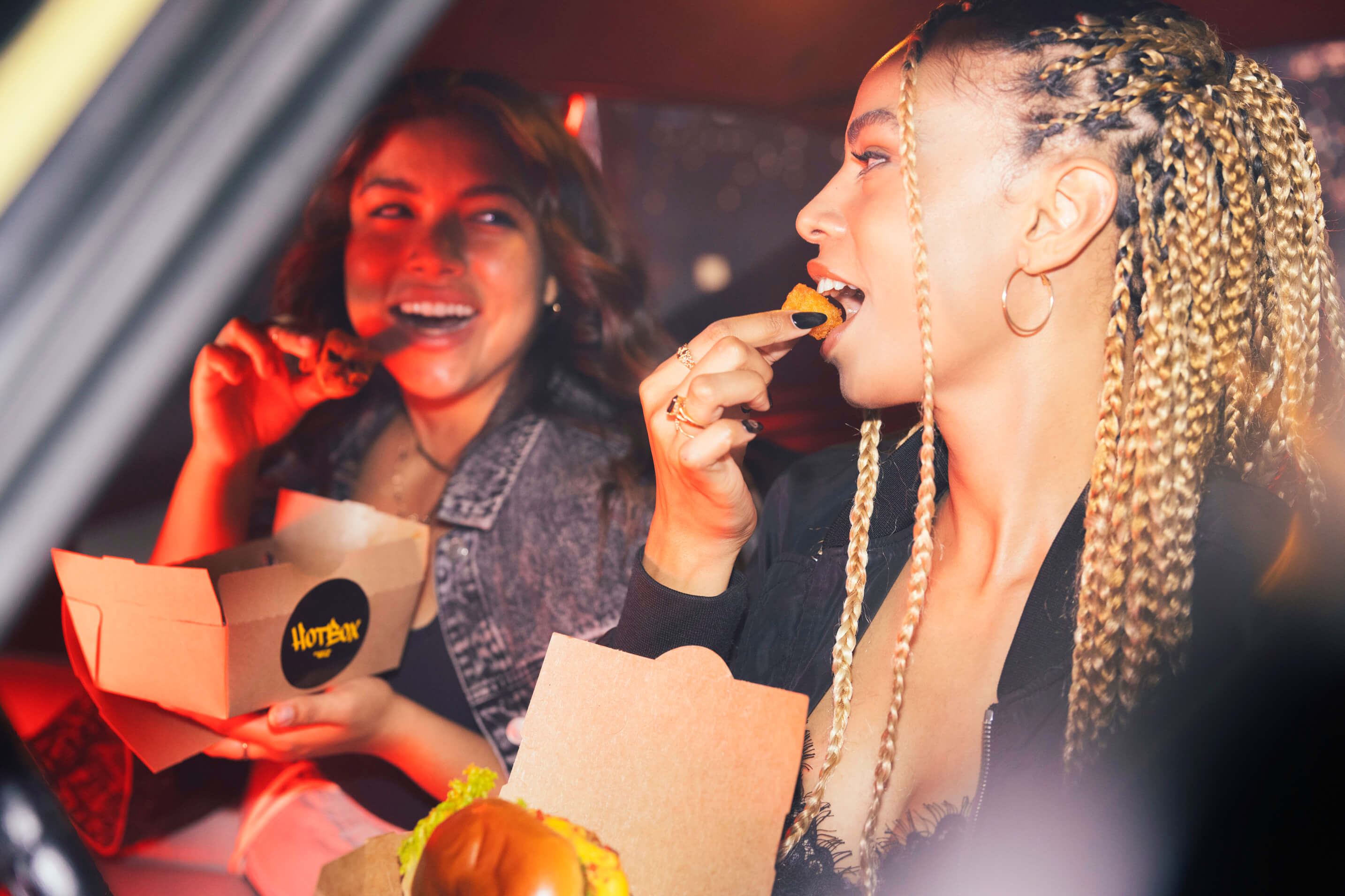 Women eating HotBox by Wiz Khalifa food