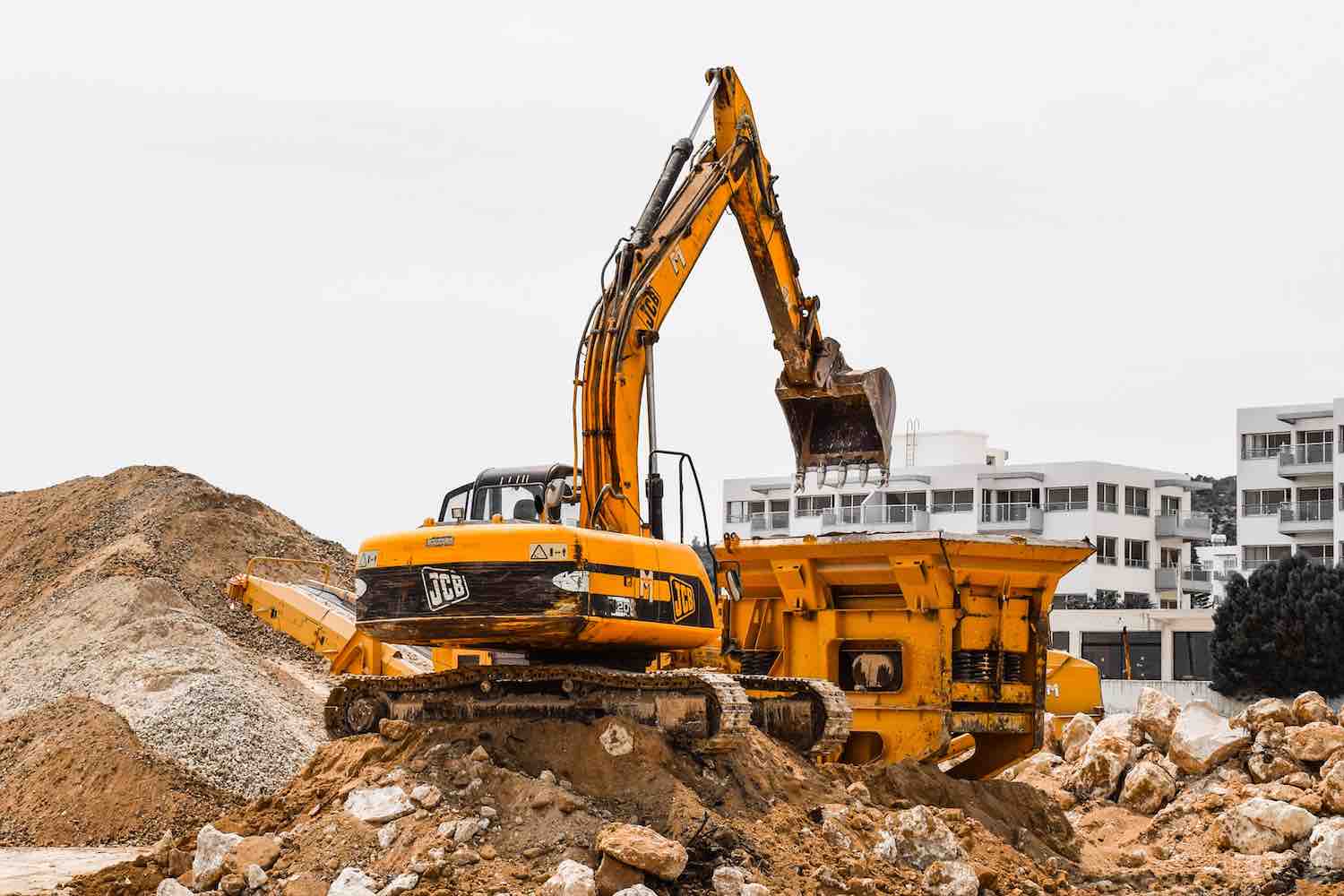 a backhoe moving dirt on a jobsite