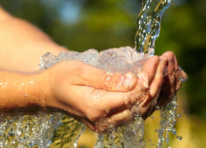 clean water flowing into a person's hands