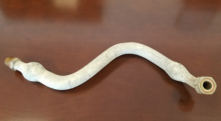 A lead gooseneck laying on a table