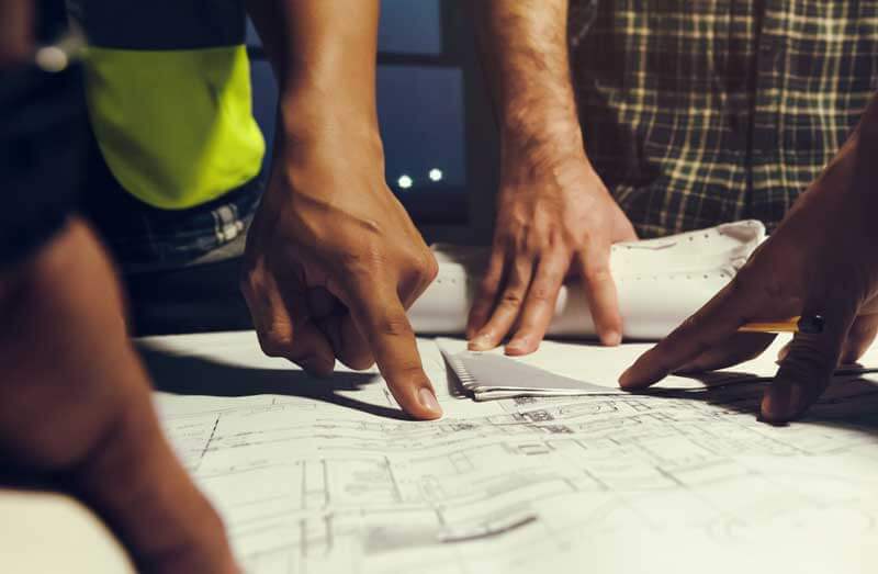 Construction project stakeholders examining as-built data
