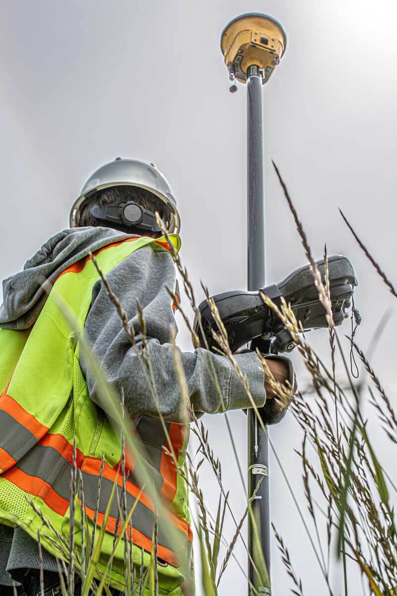 a construction worker performing an as-built survey