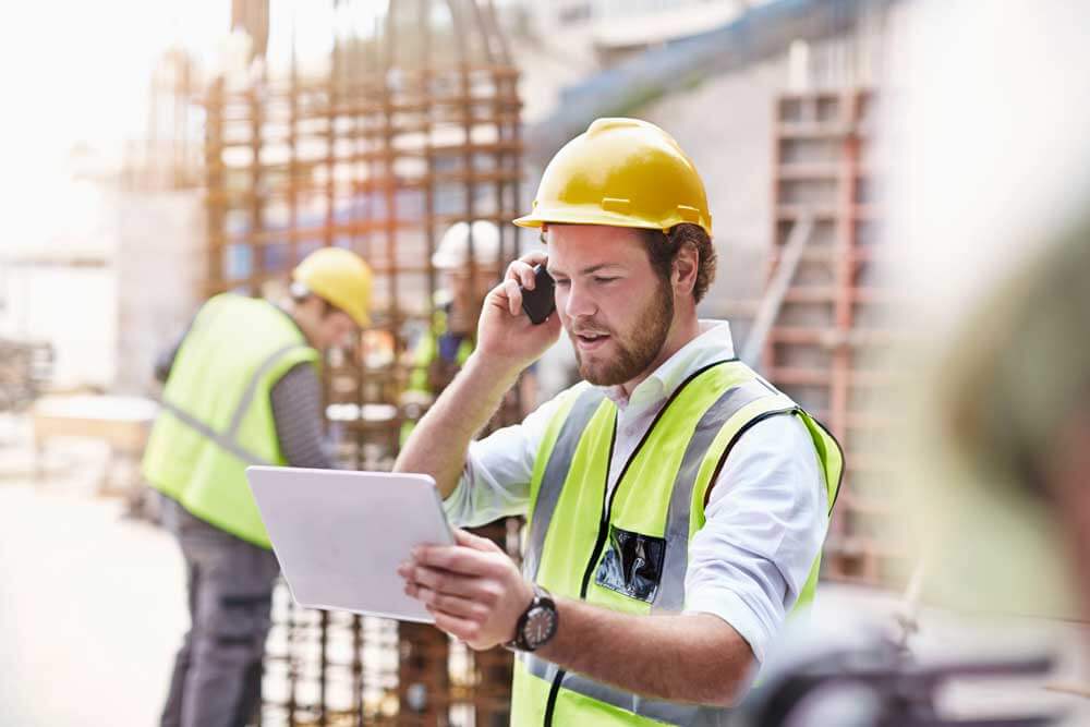 a construction worker accessing a digital as-built on a tablet
