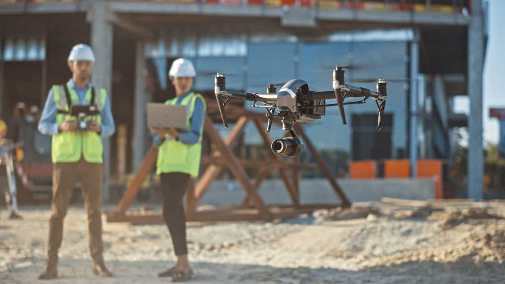 a construction team uses a drone on a construction site