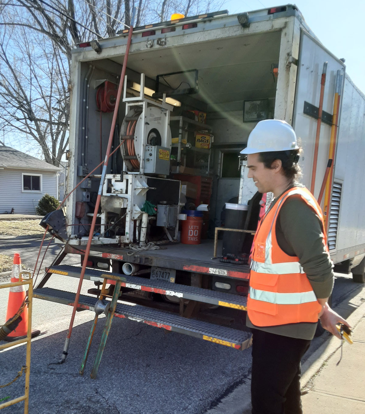 Jay watching how workers inspect underground infrastructure