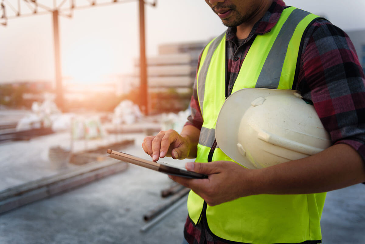 A subcontractor submits a construction progress report on a tablet for real-time progress reporting.