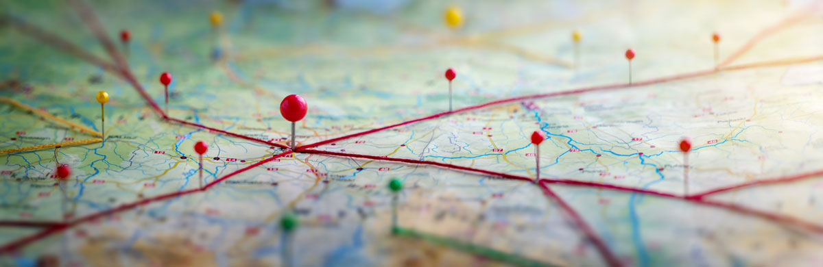 several pins stuck into a paper map