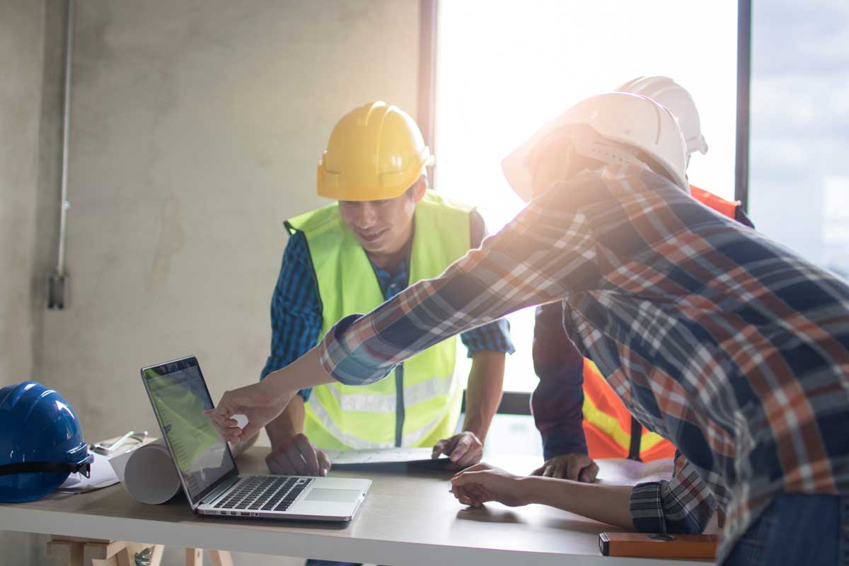 a construction team using data management software