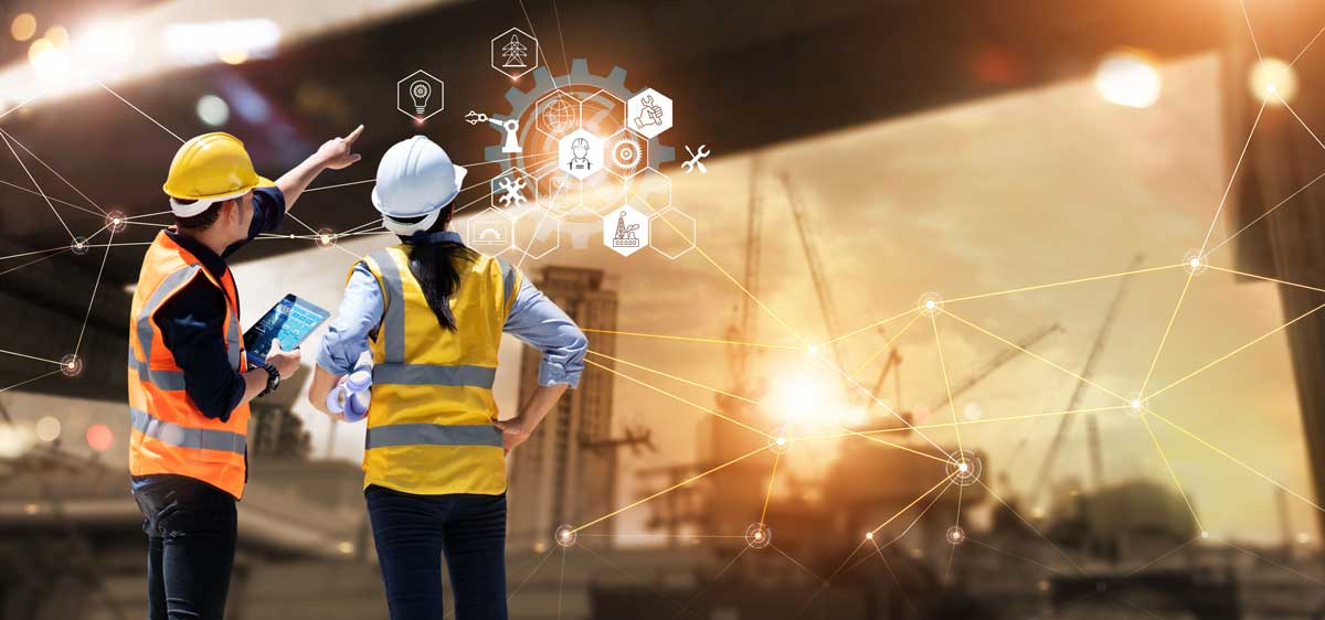 Two construction team members managing data in the field
