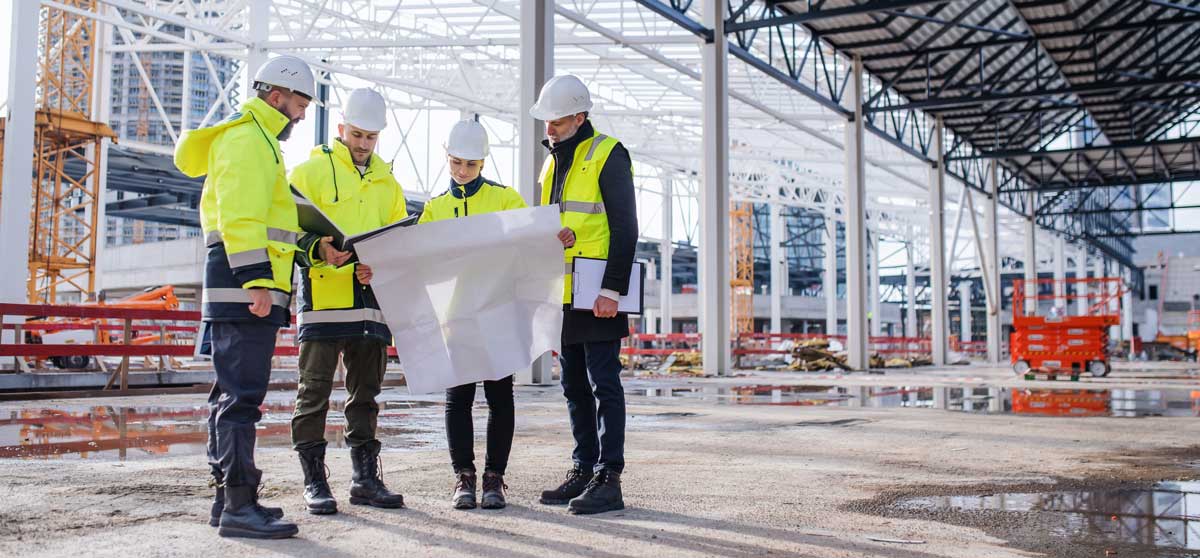 construction team referencing paper drawing