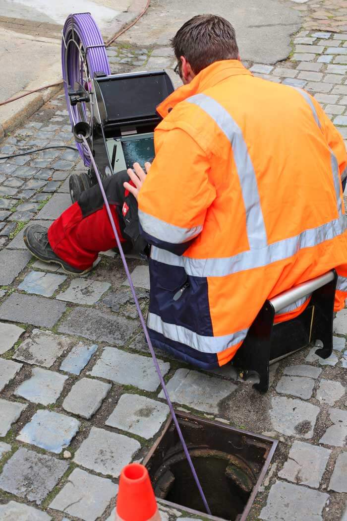 a utility field worker inspecting for cross bores