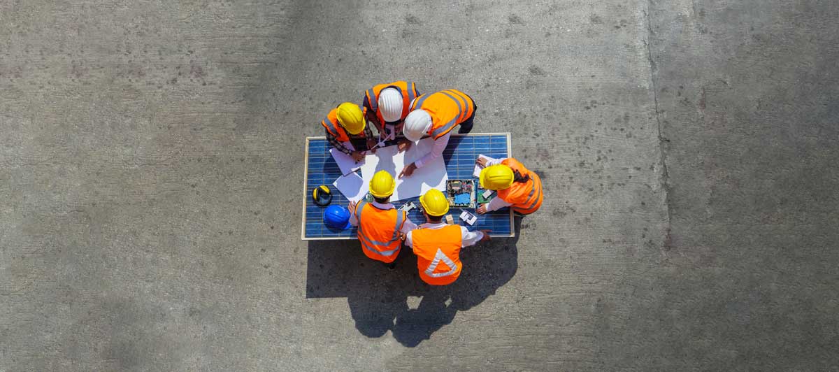 a construction team viewing a paper drawing