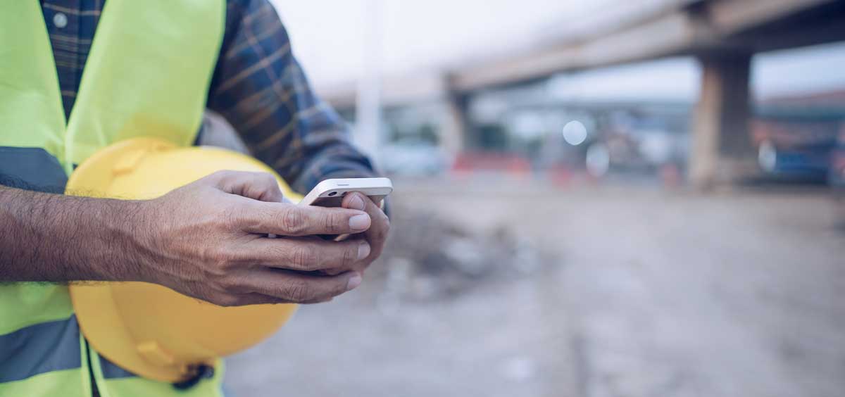 a construction engineer referencing Mobile GIS in the field