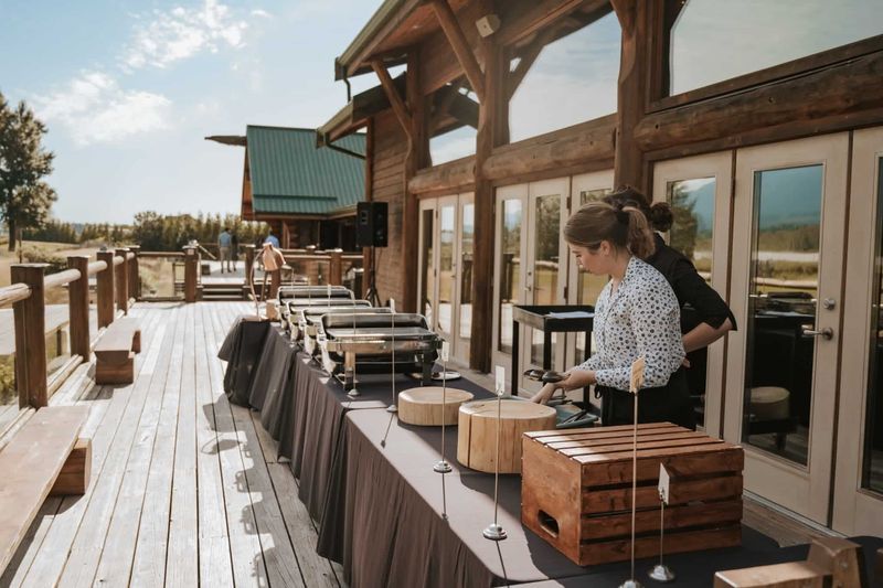 A woman prepares a wedding buffet on deck of Fraser River lodge