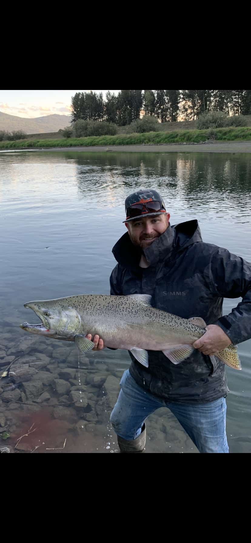 A man holding a fish in the water