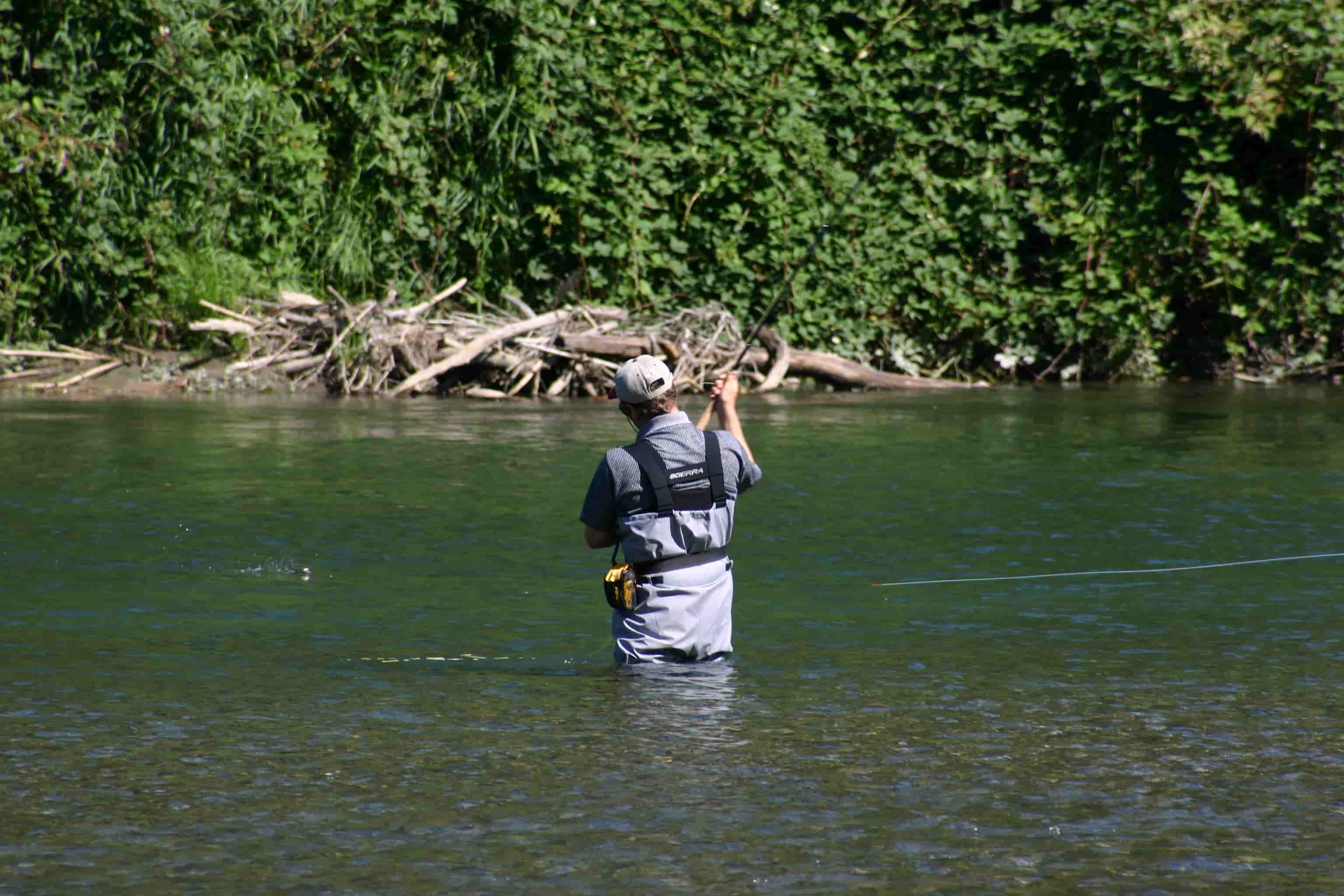 A man casting a fly fishing rod