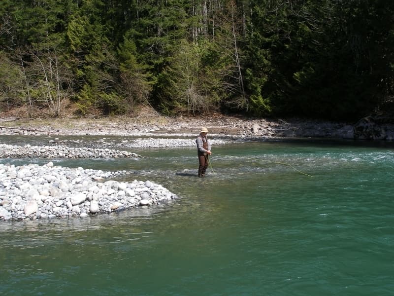 A woman holding up a salmon