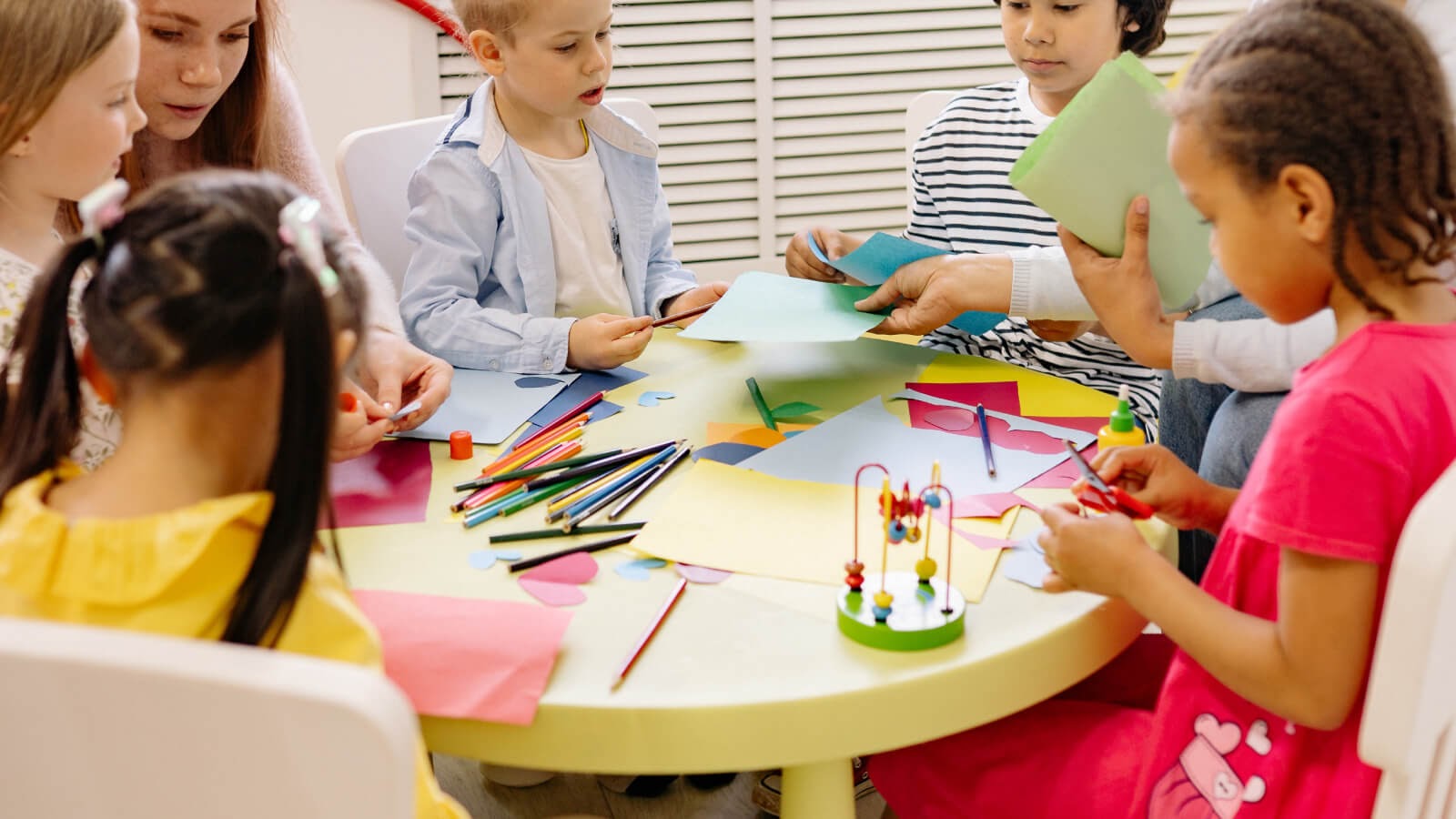 Children sat around a table involved in arts and crafts