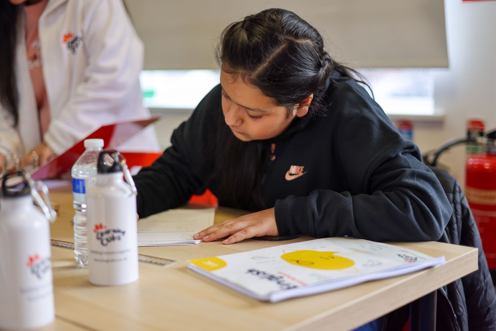 Student working hard in after school learning cubs class