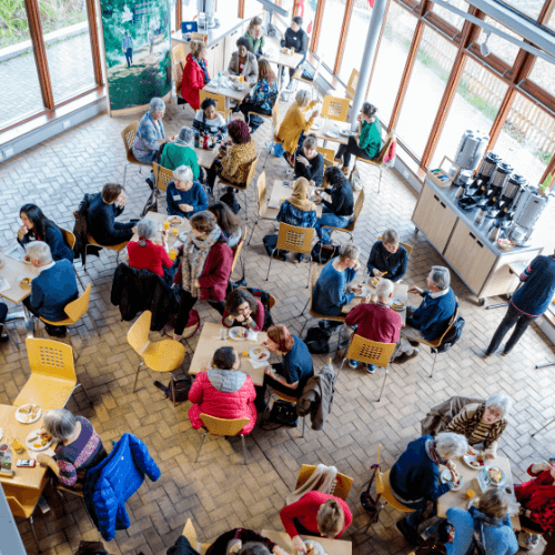 A overhead shot of befrienders sitting at tables