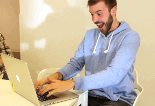 Man happily typing GIF