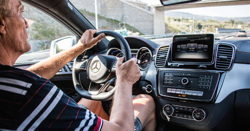 View of man driving in a car with dashboard technology